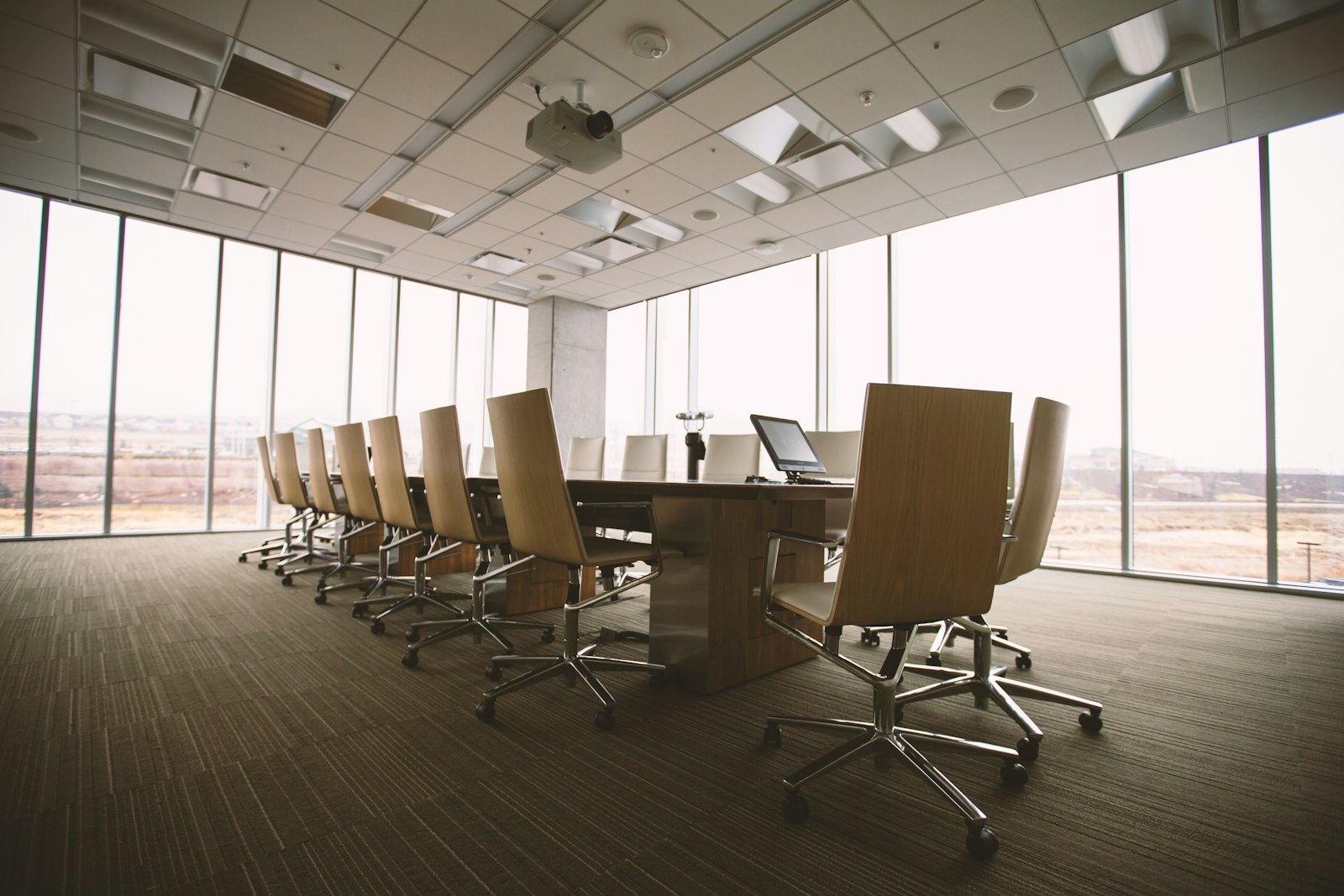 Empty modern conference room with a long table and rows of chairs, representing the setting for the Caribbean AI Forum's policy sessions