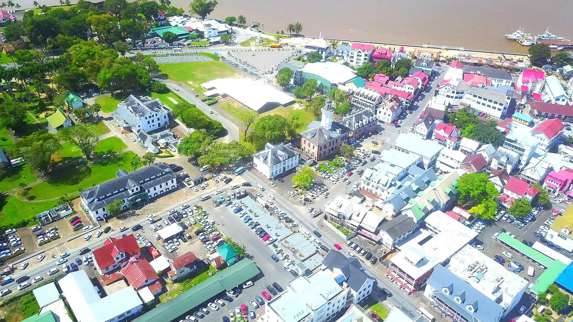 Aerial view of central Paramaribo, Suriname, with the brown Suriname River along the top of the frame
