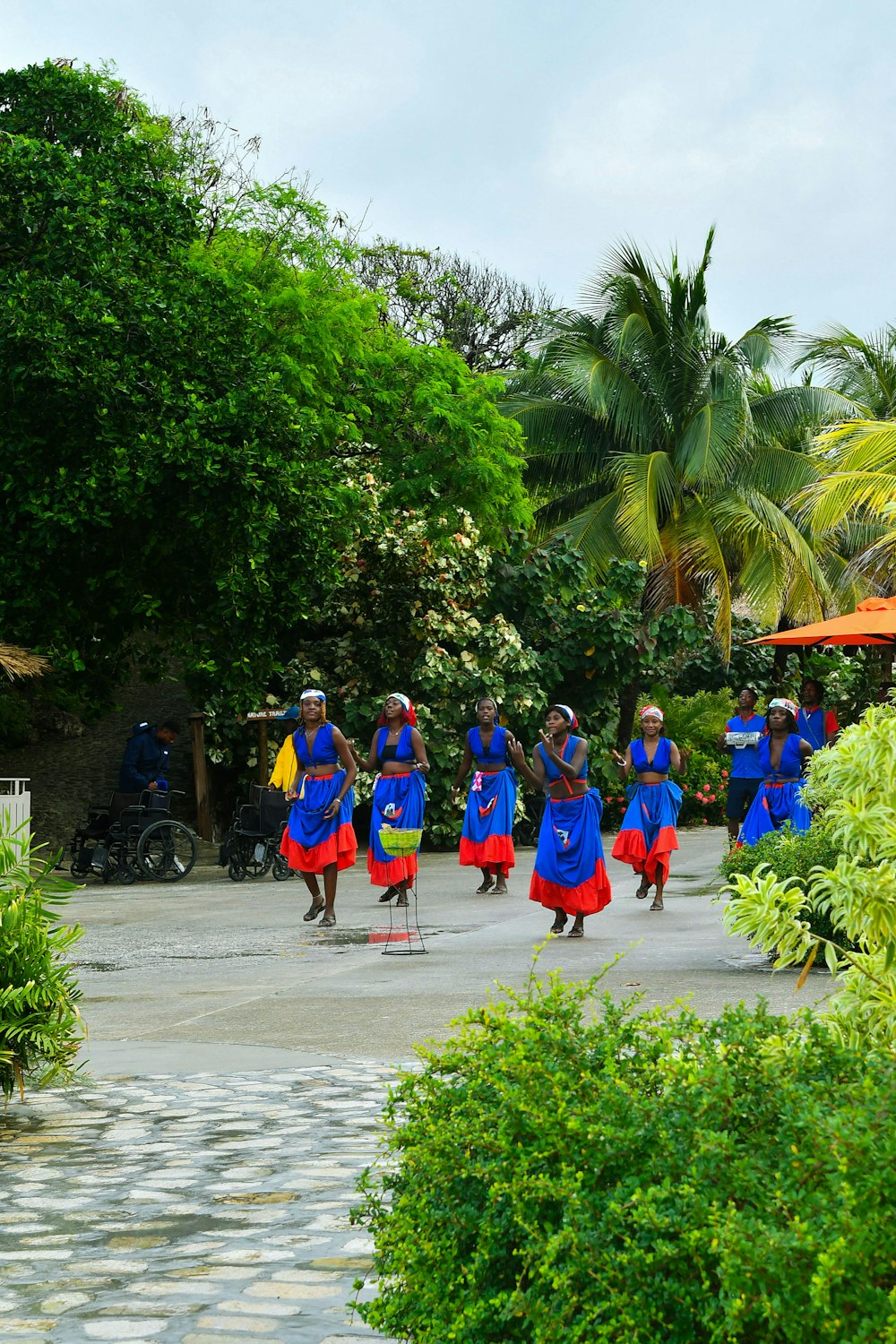 Dancers in blue and red dresses performing outdoors in Labadee, Haiti