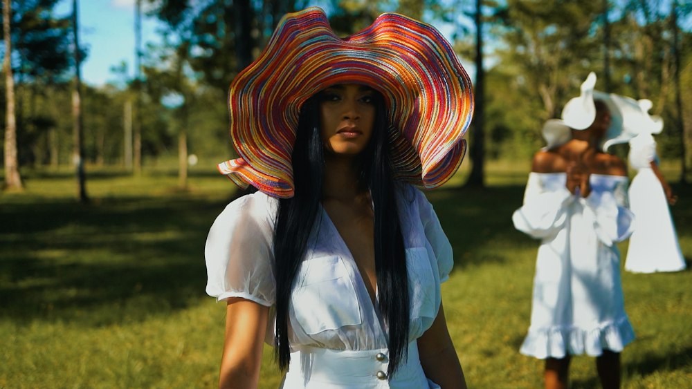 A woman in a wide, colourful sun hat
