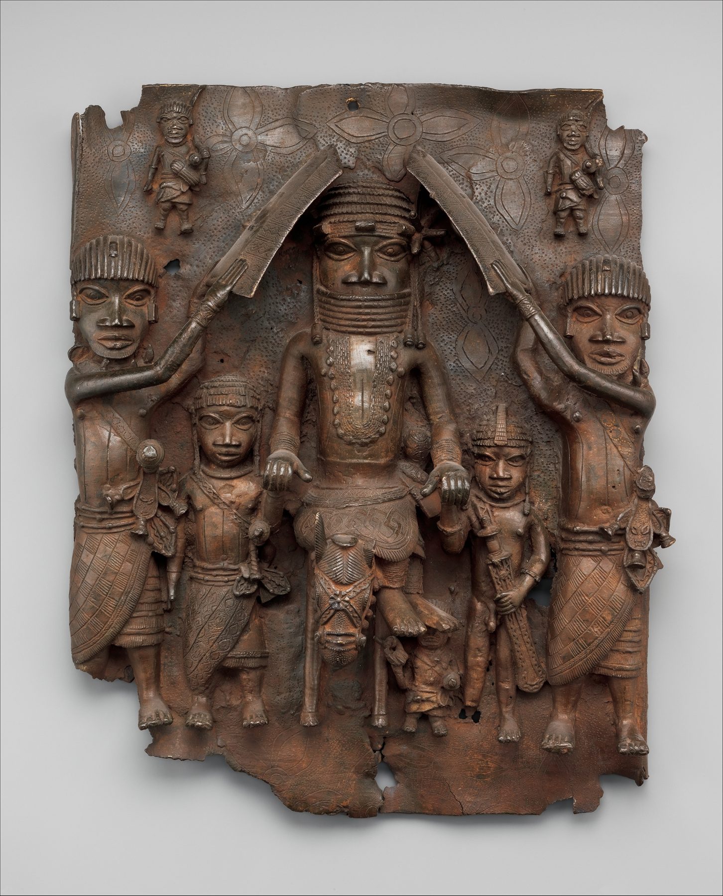 A brass relief plaque from the Kingdom of Benin showing the oba on horseback, flanked by attendants
